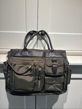 JPK Olive Green Multi-Pocket Travel Tote Bag. Nylon w leather trim.